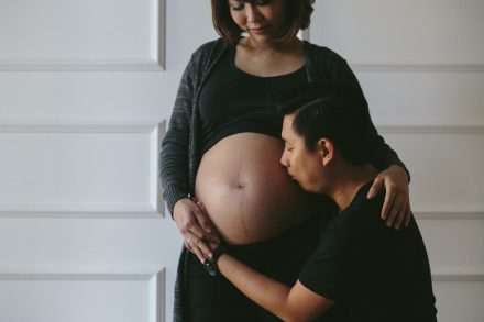 intimate maternity photoshoot in Bali with couple embracing pregnancy moment