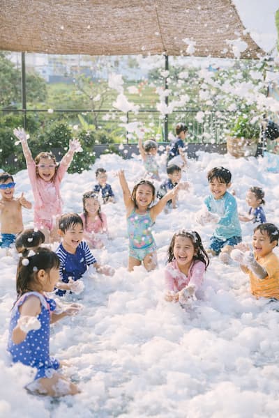 Children enjoying a foam party during an outdoor kids event