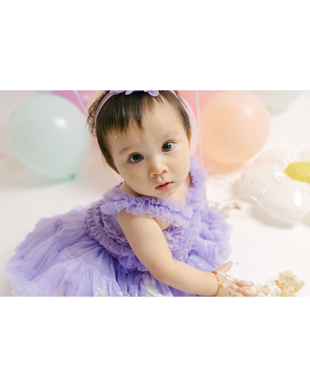 Baby portrait from a first birthday smash cake photoshoot in Bali taken by a bali smash cake photographer.