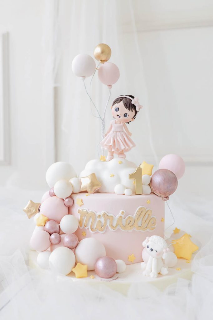birthday cake with girl character holding a balloon with pastel themes